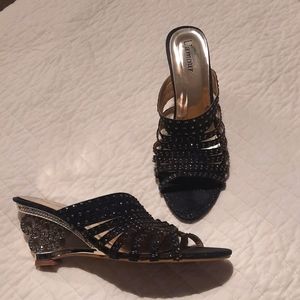 Glitzy shoes with silver colored see through heel and black rhinestones.